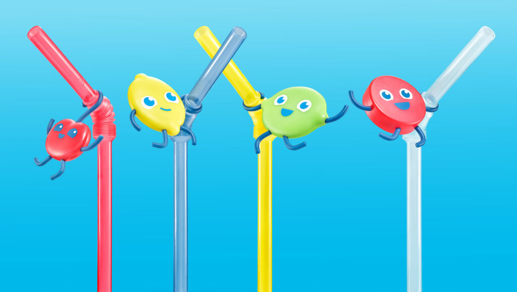 Four Sonic Wacky Pack straw accessories featuring food mascots—cherry, lemon, lime, and red button—clipped onto colorful drinking straws with small blue arms holding on.