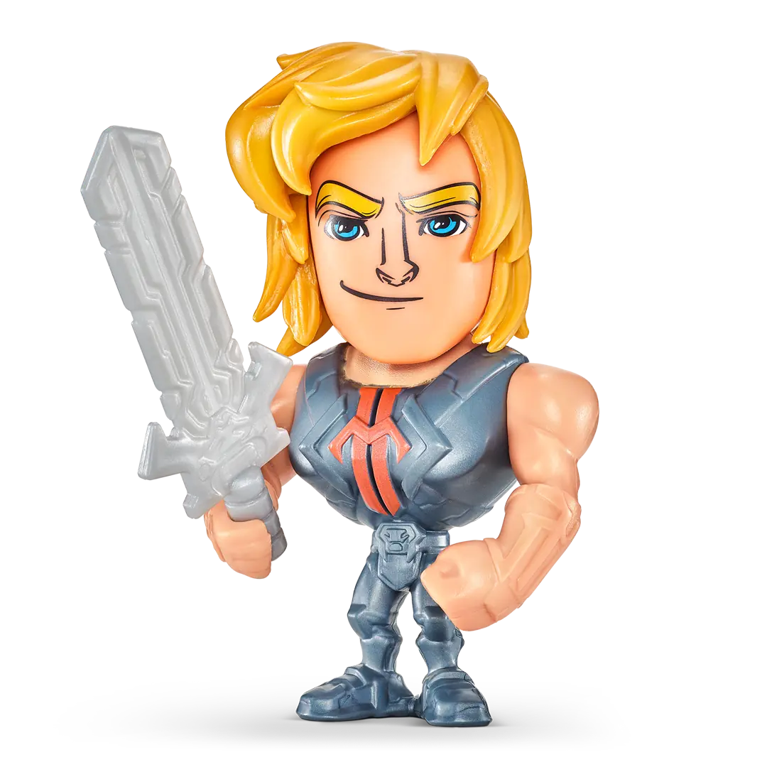Close-up of a small He-Man collectible figure. The character has blond hair, a muscular build, and wears gray armor with a red chest emblem while holding a silver sword.