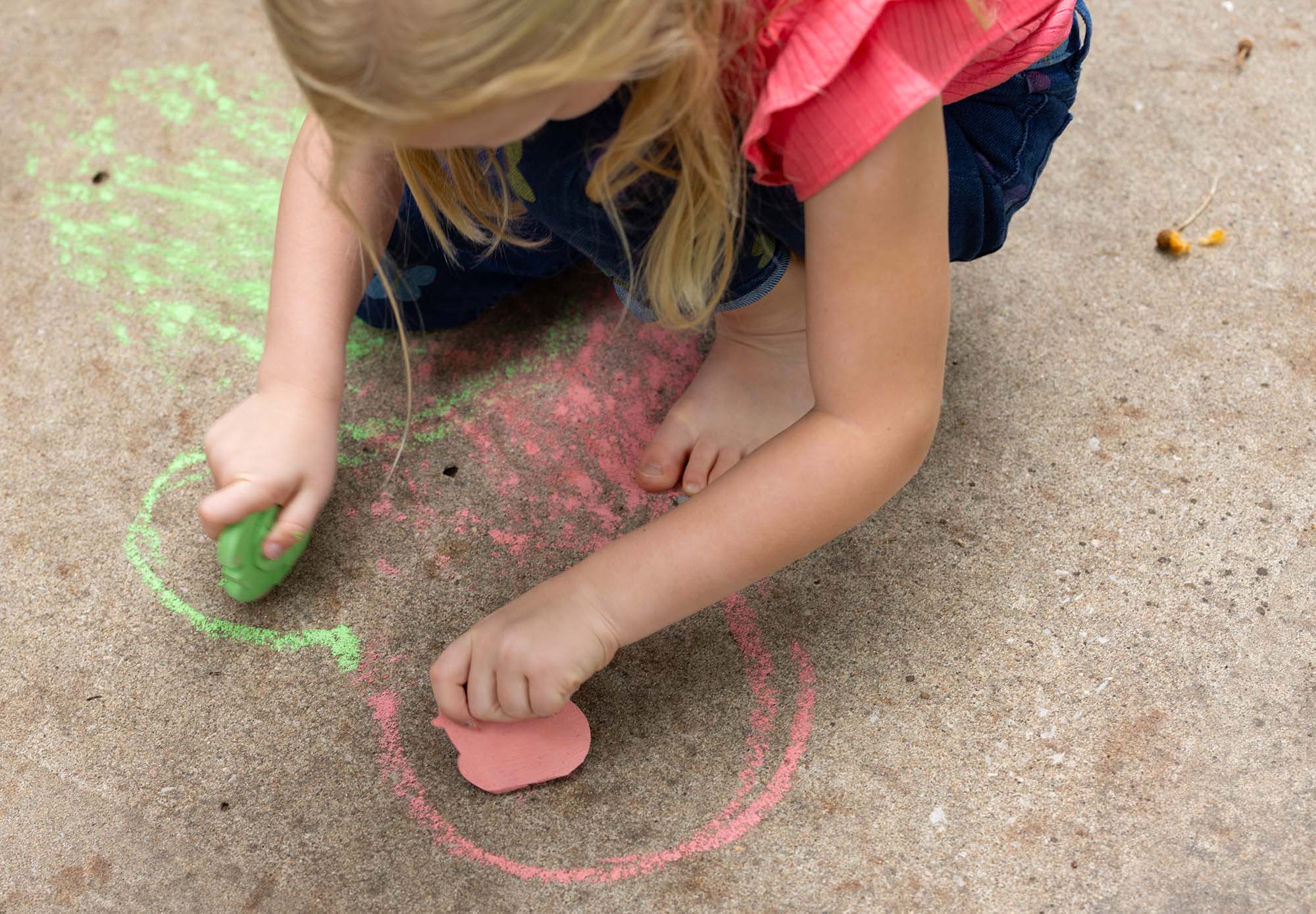 Expertise: CREATIVE; girl coloring with sidewalk chalk