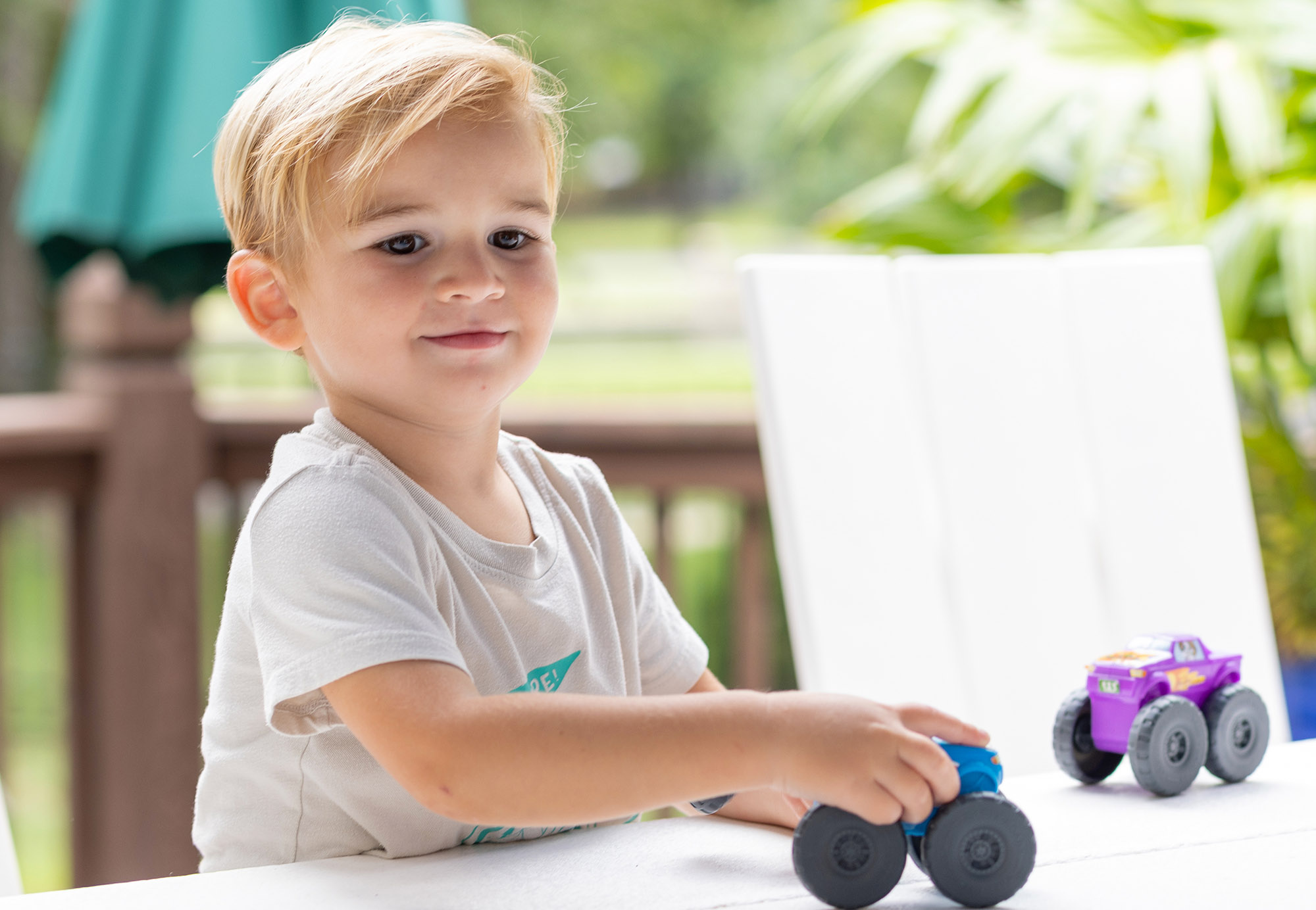 Expertise: Distribution; young boy playing with toy trucks