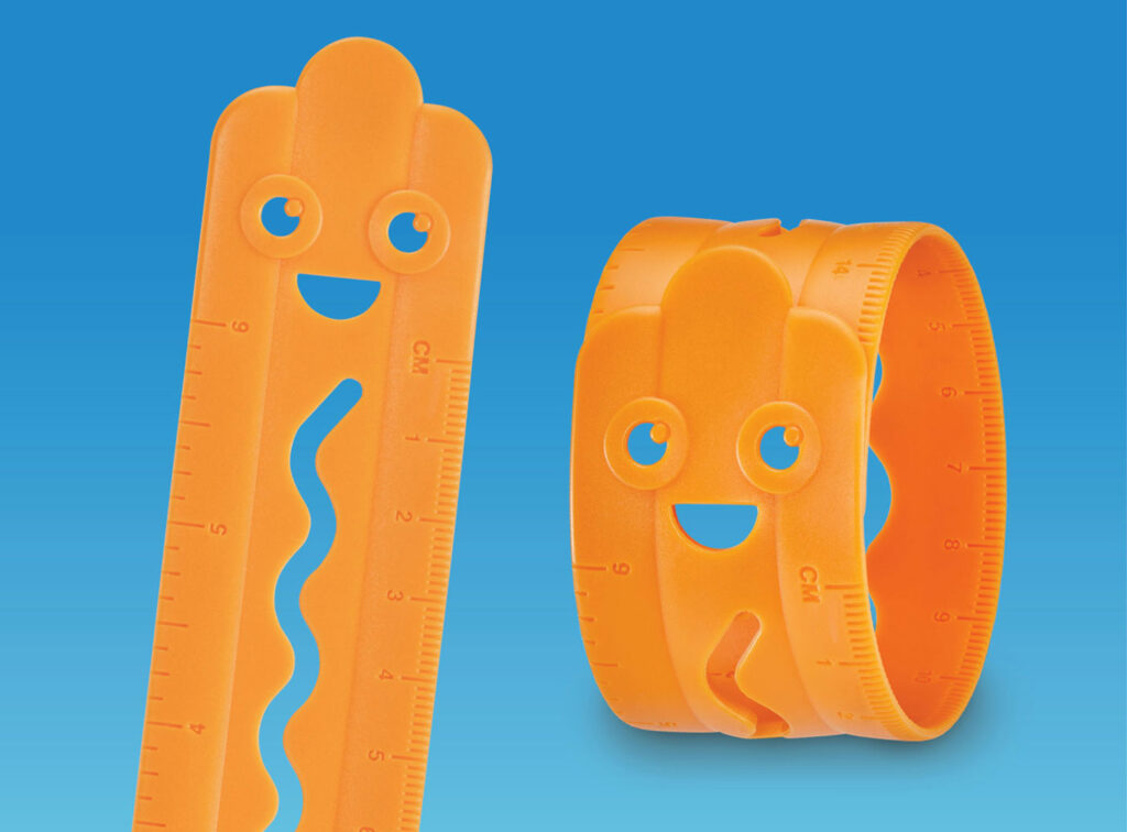 Two orange Sonic character silicone rulers shaped Frankie the Coney. One is flat with measurement markings, while the other is curled into a bracelet form.